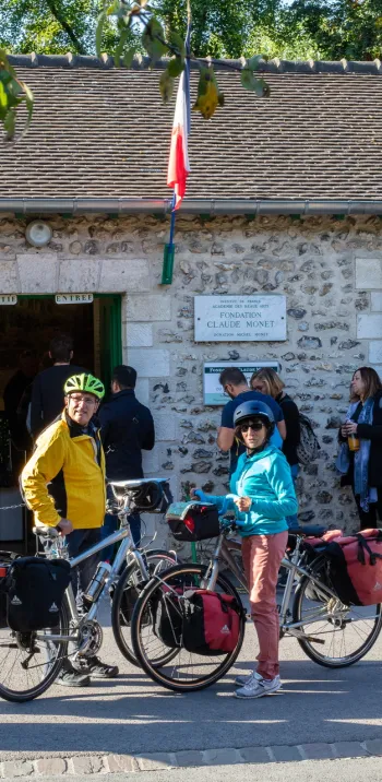 Voyageurs à vélo devant l'entrée de la maison de Claude Monet à Giverny